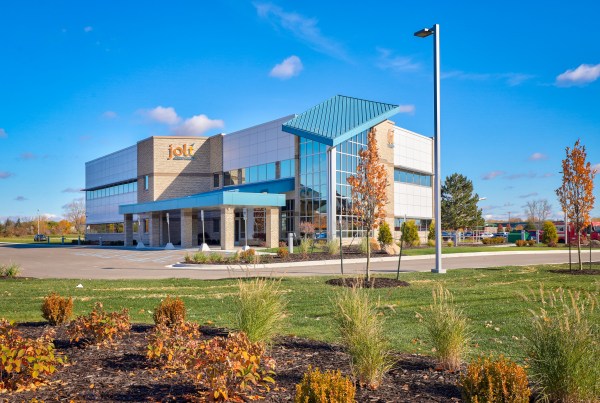 Lawn in Bay City, Michigan being aerated and overseeded in the fall by Garpiel Group, showing healthy grass and professional lawn care services.